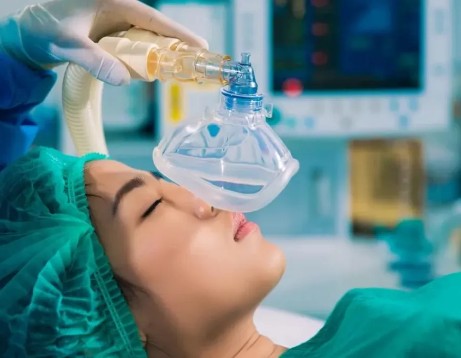 Patient laying on hospital bed about to be put under by a nurse anesthetist